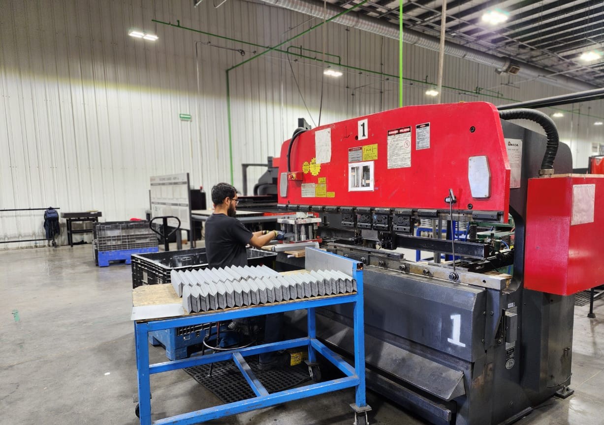 Brake machine Workers in a warehouse setting